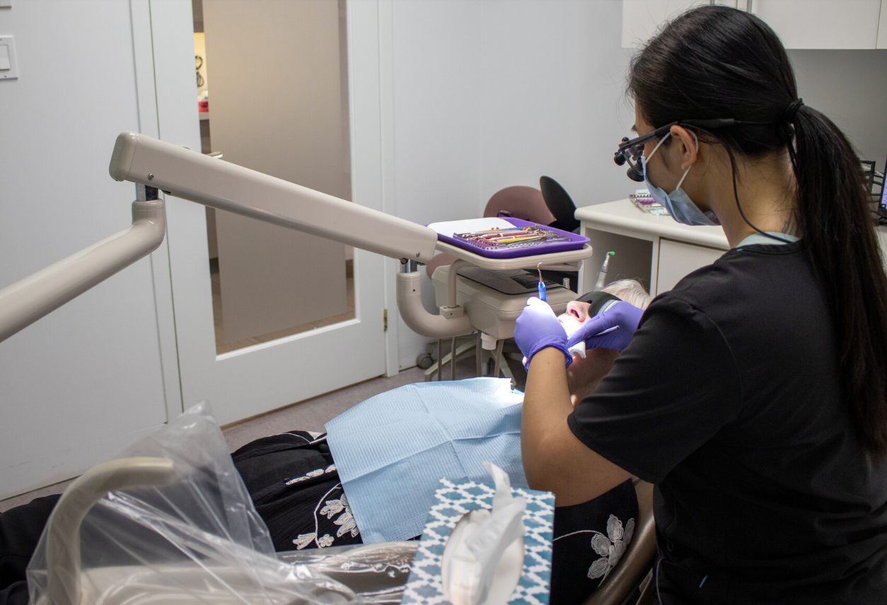 Dental professional preparing Invisalign treatment in the clinic